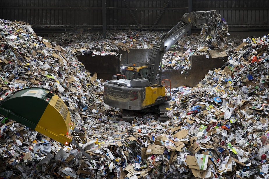 caption: A large pile of recyclables forms where arriving trucks dump the materials before they are sorted on Friday, October 26, 2018, at Cascade Recycling Center in Woodinville.