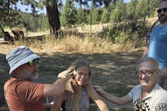 caption: Lynn O'Connor is treated by family and friends after she was attacked by a bear on her property near Kettle Falls, Washington.