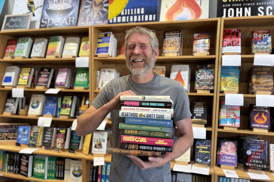 caption: Dan Ullom owns Brick and Mortar Books in Redmond Town Center, about one block away from the new light rail station.