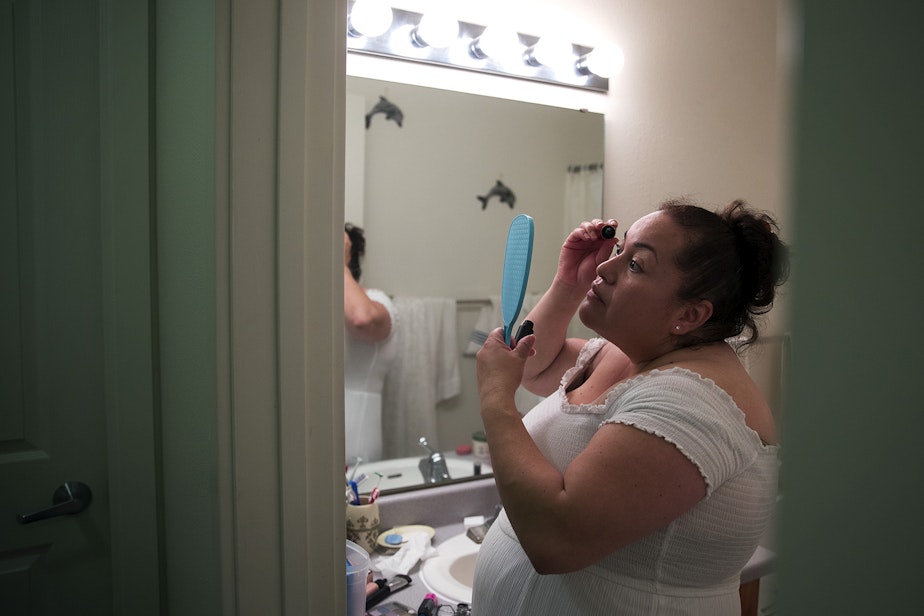 caption: Ana Dely Morales puts mascara on before marrying her partner of 16 years, Ramon Sanchez Cordova, in a mass wedding ceremony on Sunday, June 2, 2019, at Our Lady of the Desert Church in Mattawa.