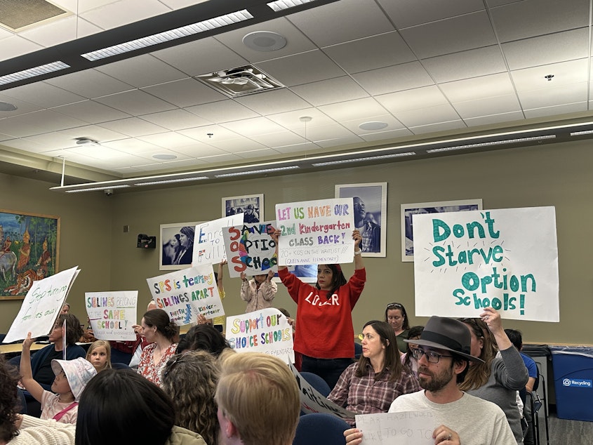 caption: About a dozen parents and educators spoke out against the district's enrollment and waitlist practices at the Seattle School Board meeting April 24, 2025.