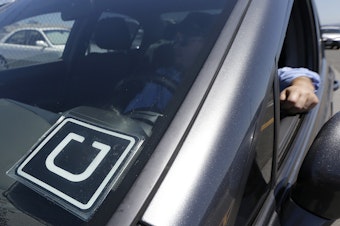 caption: FILE: An Uber driver near the San Francisco International Airport.