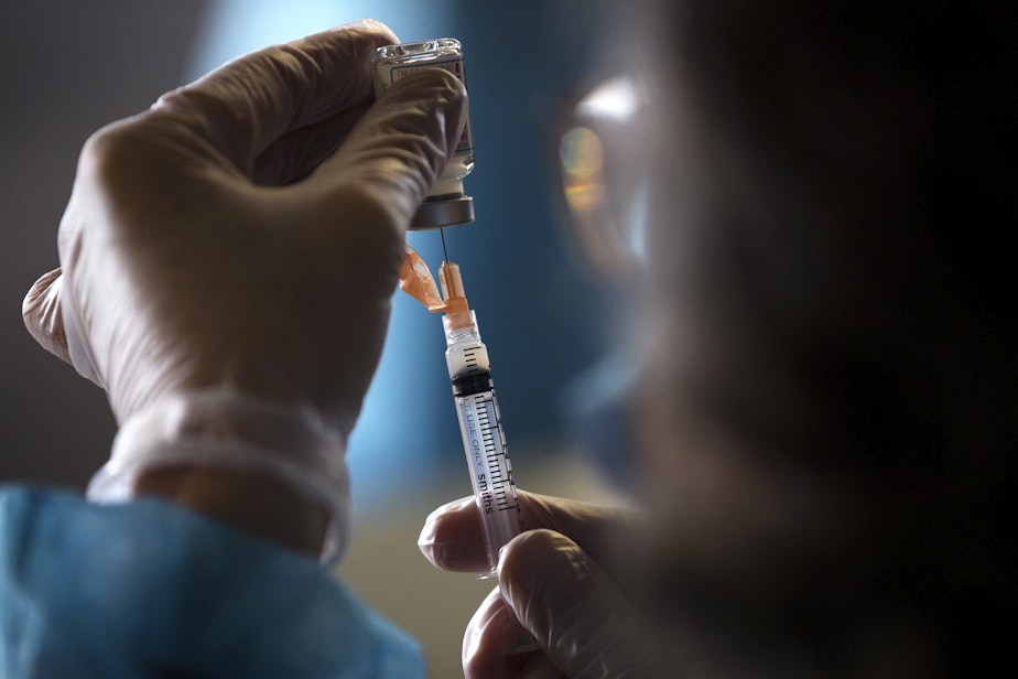 caption: Doses of the Moderna Covid-19 vaccine are drawn out during a vaccine clinic set up by the Somali Health Board to vaccinate 100 seniors on Wednesday, February 3, 2021, at Brighton Apartments, a complex for seniors, on Rainier Avenue South in Seattle.