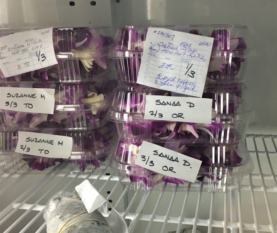 caption: Lei waiting in the refrigerator at the Hawai'i General Store in Seattle. Lei are kept cold to preserve their beauty.
