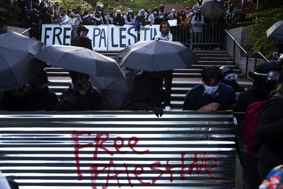 caption: The east entrance to the University of Washington quad and encampment for Palestine is shown barricaded following a talk by Turning Point USA founder Charlie Kirk on Tuesday, May 7, 2024, in Seattle.