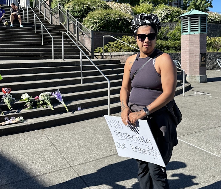 caption: Alyssa Marsh, parent of an 8th grader at Washington Middle School who is reconsidering whether to attend Garfield High School next year due to neighborhood gun violence. Marsh joined a community march at Garfield the morning after a fatal school shooting there.