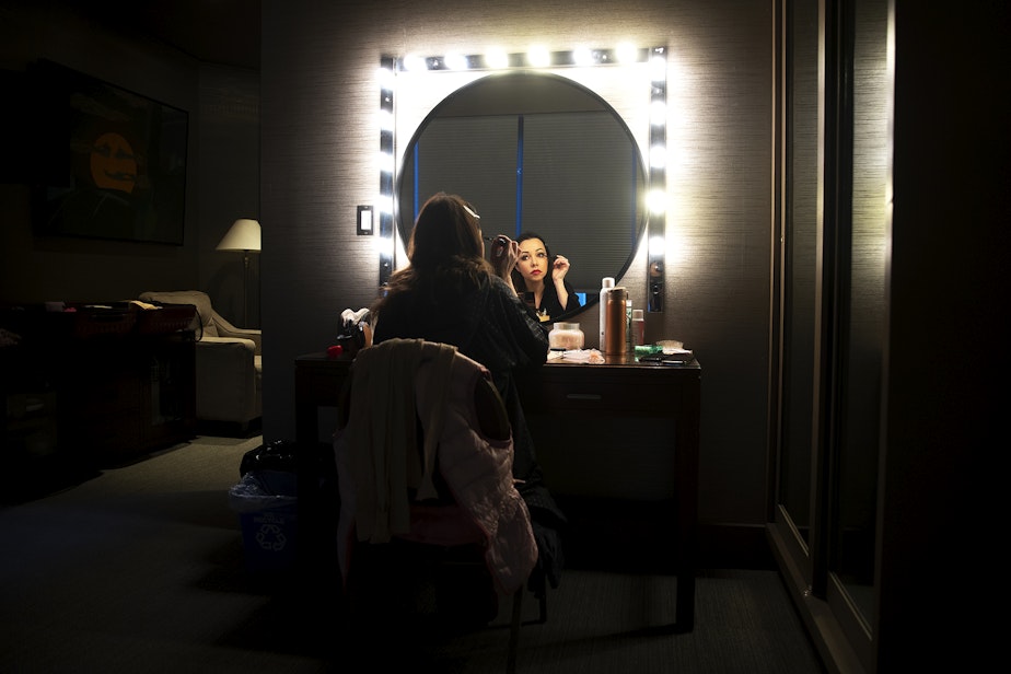 caption: Kateryna Kukhar, principal dancer with the Grand Kyiv Ballet, applies makeup in a dressing room before performing as Cinderella in Snow White, on Wednesday, December 20, 2023, at the Paramount Theatre in Seattle.