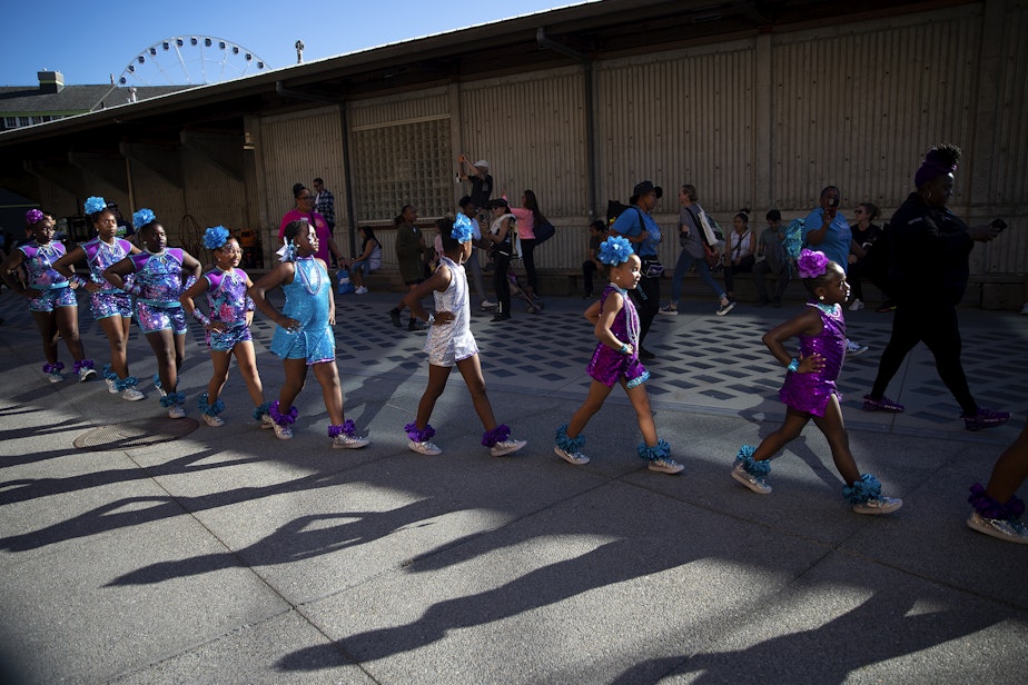 caption: The Daughters of Royalty and Washington Diamonds drill teams arrive to perform at the fourth annual Waterfront Block Party on Friday, August 30, 2024, at Pier 62 in Seattle.