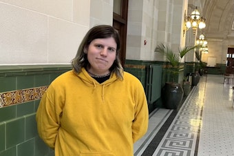 caption: Lexi Young, a transgender woman, works as a fare ambassador for Sound Transit. A Seattle man is charged with a hate crime assault against Young while she was working on Sept. 14, 2024.