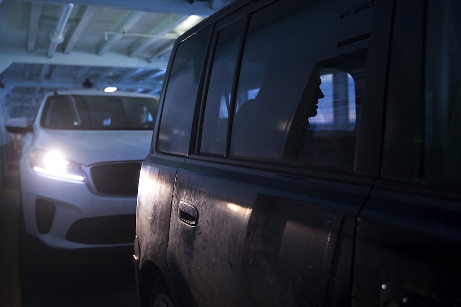 caption: Hope Black breathes through a contraction in the back seat of their vehicle while on the ferry en route to the hospital from Vashon Island, at 8:34 p.m. on Friday, May 28, 2020, in Seattle.
