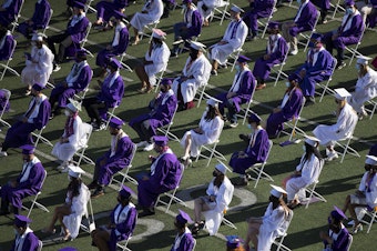 caption: Garfield High School seniors graduate in-person on Tuesday, June 15, 2021, at Memorial Stadium in Seattle. 