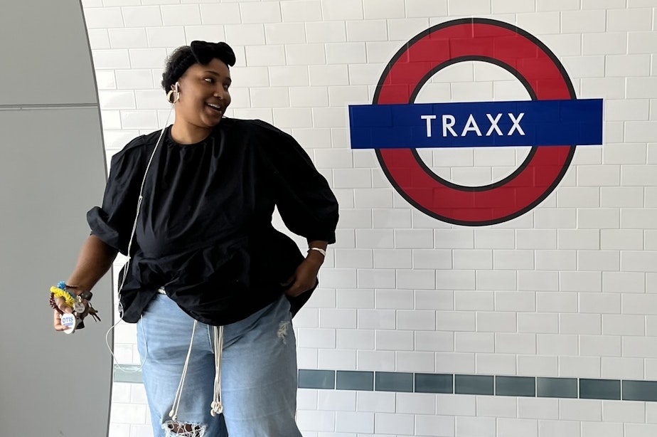 caption: Zara Bensouda at the Traxx apartments entry, Mountlake Terrace