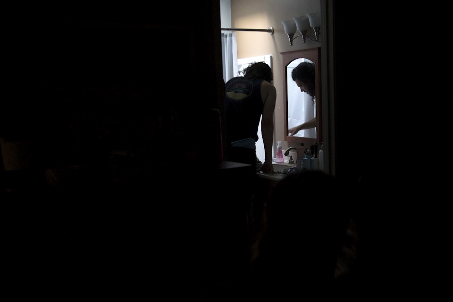 caption: Jake Black checks on his wife, Hope Black, as she labors in the bathtub at 5:27 a.m., on Friday, May 28, 2020, at their home on Vashon Island.