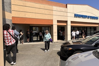 caption: A long line formed outside the Shoreline office of the Washington Department of Licensing on Wednesday, April 23, two weeks before the federal REAL ID law is set to take effect.
