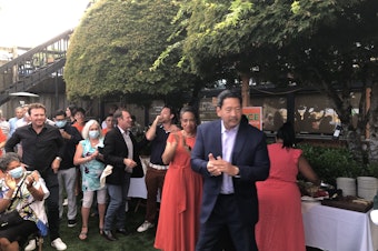 caption: Mayoral candidate Bruce Harrell reacts to initial results. His campaign gathered at a restaurant in Seattle's Leschi neighborhood on the night of election primaries, Aug. 3, 2021. 