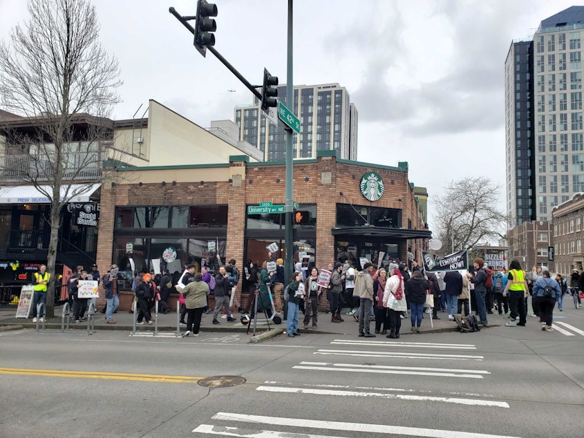 caption: Starbucks Workers United rally outside the University District Starbucks March 11 in Seattle. Workers were demanding a fair contract and decrying union busting by the coffee giant.