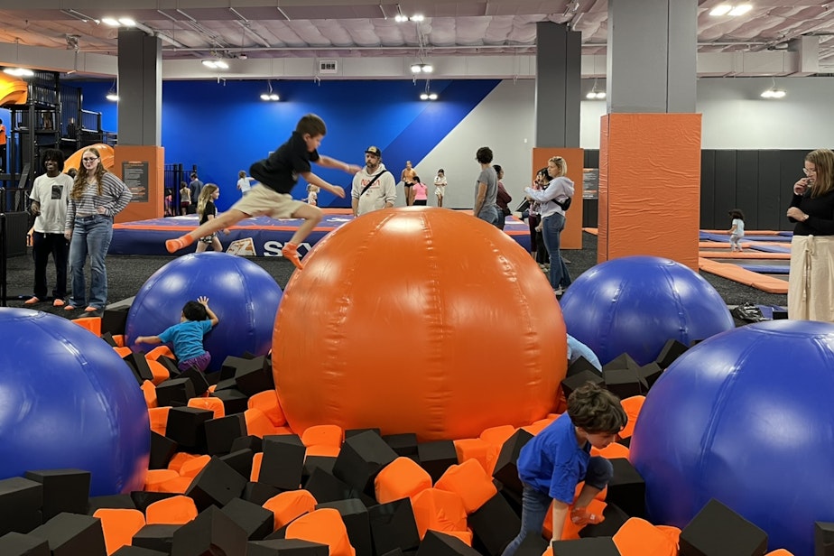 caption: Children jump at Sky Zone in Mountlake Terrace's new neighborhood near the light rail station