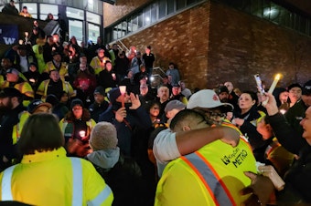 caption: Metro bus drivers gather at tribute to Shawn Yim on Dec. 21.