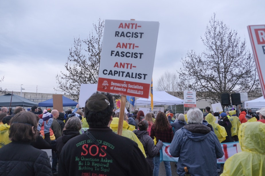 caption: Hundreds rally outside the ICE detention facility in Tacoma on March 27, 2025.