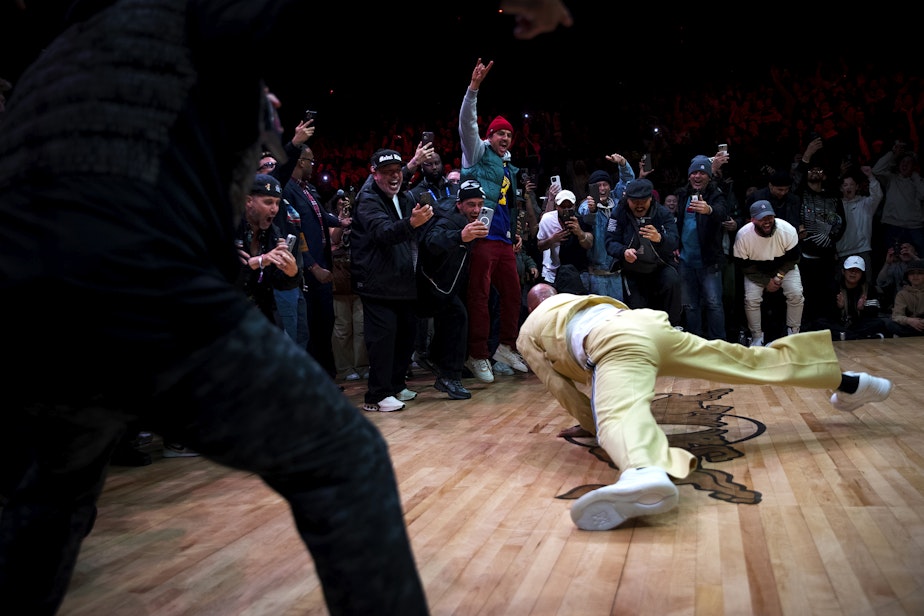 caption: The crowd reacts as hip-hop artist and actor Common puts on his own, unexpected breakdance show while performing at the Red Bull Lords of the Floor competition on Saturday, April 6, 2024, at WAMU Theater in Seattle.