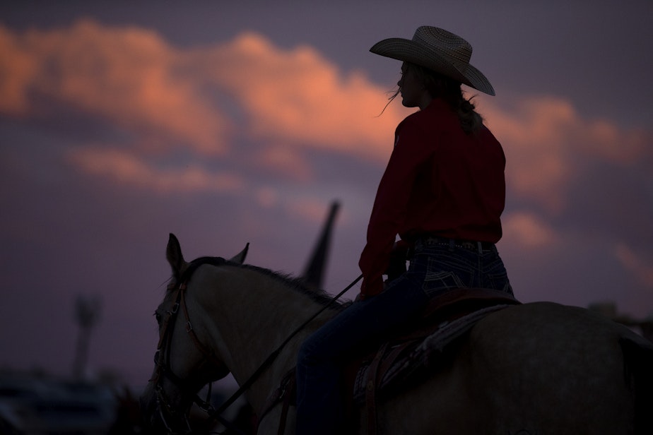 caption: The sun sets on Friday, June 17, 2022, at the Freedom Rodeo in Basin City.