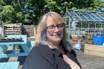 caption: Cherie Liberty has volunteered at the University District Food Bank since 2016, and served as an AmeriCorp member since November of last year. She says the administrative pause has been "traumatic."