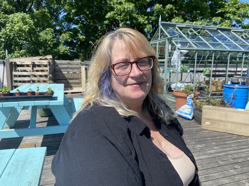caption: Cherie Liberty has volunteered at the University District Food Bank since 2016, and served as an AmeriCorp member since November of last year. She says the administrative pause has been "traumatic."