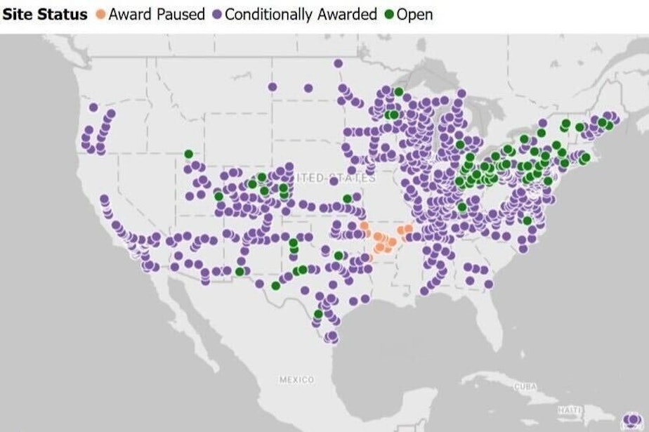 caption: Washington state is a blank spot on a map by EV States Clearinghouse that shows, in green, where states have opened vehicle charging stations using federal NEVI funds and, in purple, where states have awarded contracts to build chargers with those funds.
