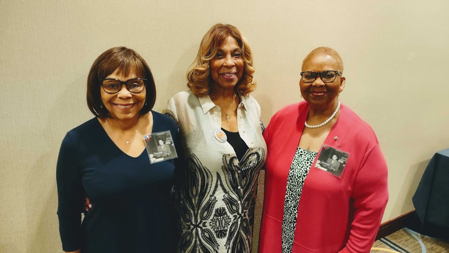 caption: From left to right, Sandra Dean Frazier, Denise McBride, Beverly Sonnier all wearing photos of their mothers who served in the Six Triple Eight