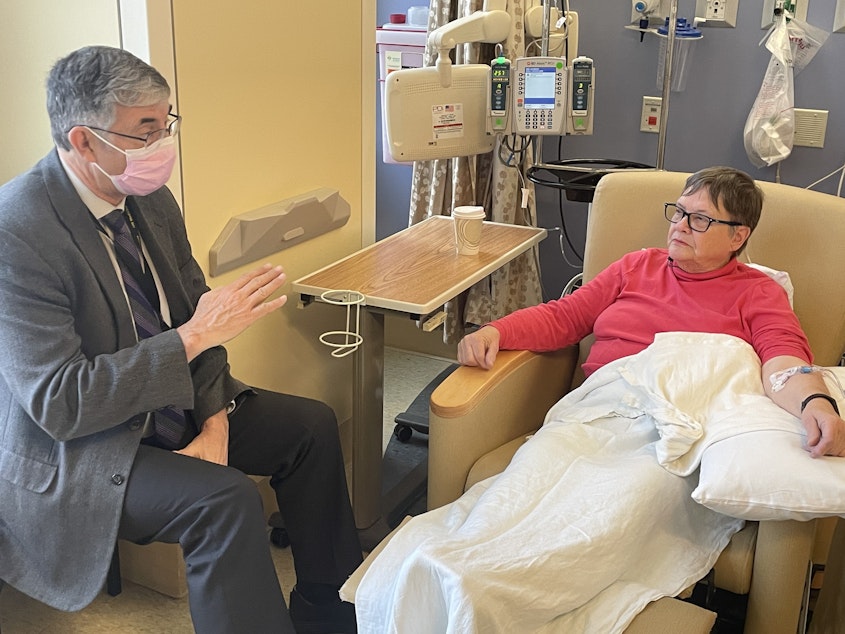 caption: Dr. Thomas Grabowski, left, a professor of radiology and neurology at the UW School of Medicine and director of the UW Alzheimer Disease Research Center, talks with Andrea Gilbert, 79, while she is treated with a new Alzheimer's drug called lecanemab.