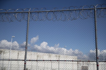 caption: A fence outside of the Northwest Detention Center, renamed the Northwest ICE Processing Center, is shown on Tuesday, Sept. 10, 2019, in Tacoma. 