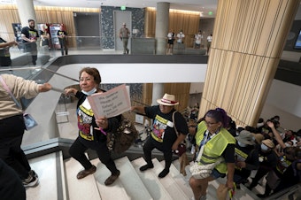 caption: Supporters of a bill to give domestic workers the same safety protections required by law for other employees, march through the Capitol Annex Swing Space office building in Sacramento, Calif., Tuesday, Aug. 29, 2023. 