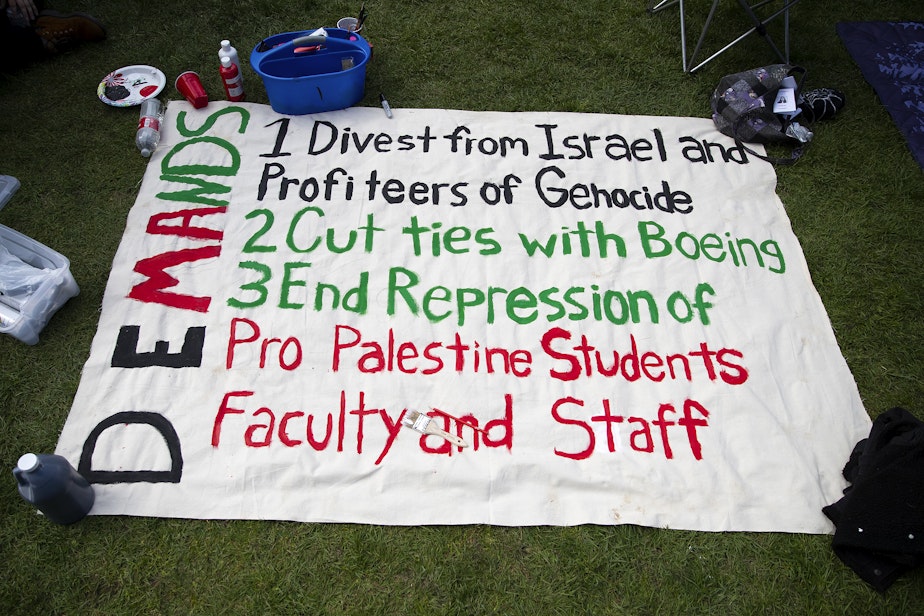 caption: A list of demands from University of Washington students protesting in support of Palestine is shown at the UW Palestine Encampment on Monday, April 29, 2024, on the northeast corner of the Quad on the University of Washington campus in Seattle.