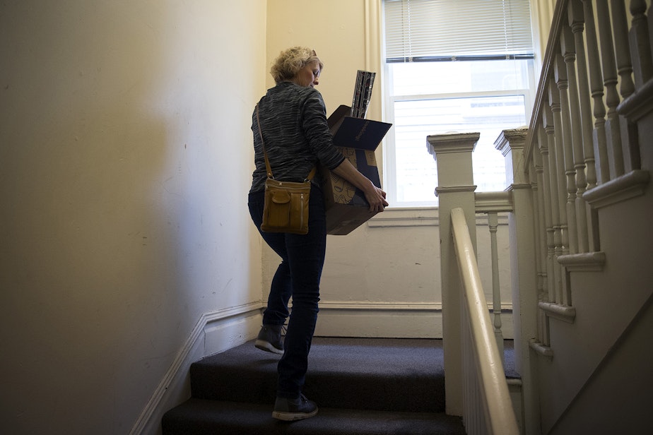 caption: Jerri Clark carries a box of her son Calvin's belongings to her car on Friday, March 22, 2019, in Seattle. Calvin, who suffered from severe mental illness, took his own life four days earlier.