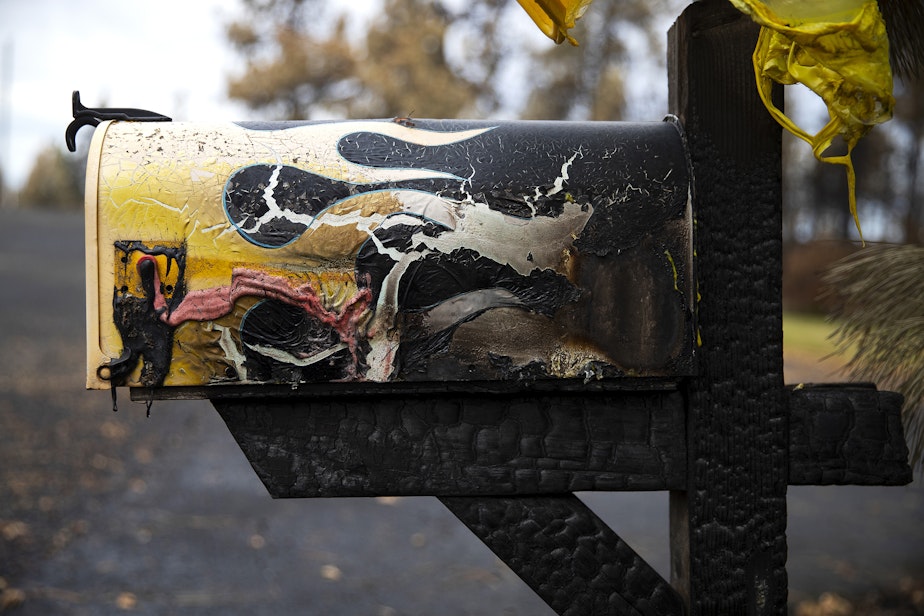 caption: Flames painted on a mailbox are shown charred by the Gray Fire that burned over 240 homes and over 10,000 acres on Sunday, September 3, 2023, along the west side of Silver Lake in Spokane County.