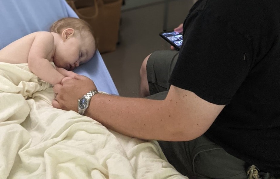 caption: Jim Guerber with his son Holden at Children's Hospital in Seattle last month. Holden was sick with Covid-19.