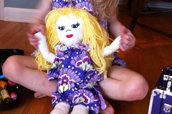 caption: Marlo Mack's daughter with her baby doll.