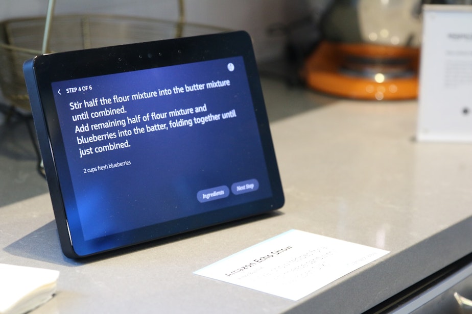 caption: An Echo Show guides Joshua through a recipe at Amazon's secret smart home lab in the Amazon Day One building.