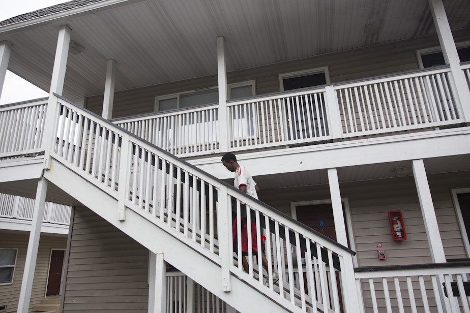 caption: Osman Mohamed outside his apartment complex in Federal Way.