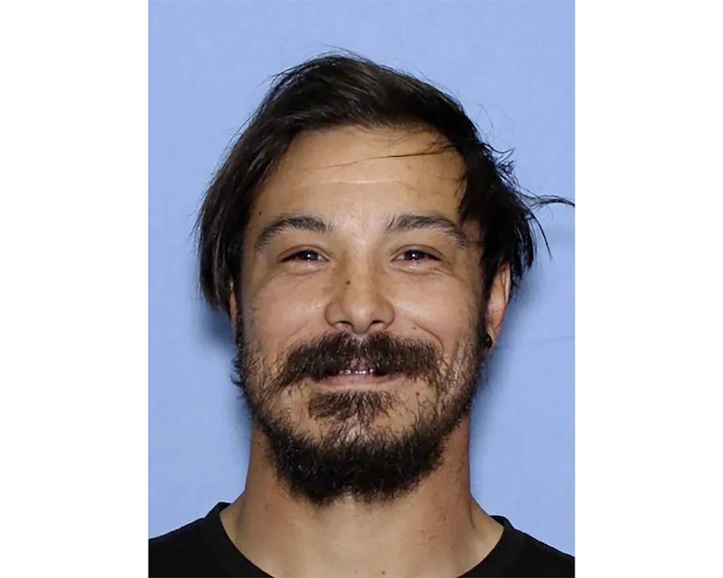 caption: This undated photo provided by the Wenatchee Police Department shows Travis Caleb Decker who the police are asking the public for help in locating the Washington state father who is wanted for murder after his three young daughters were reported missing and then found dead.