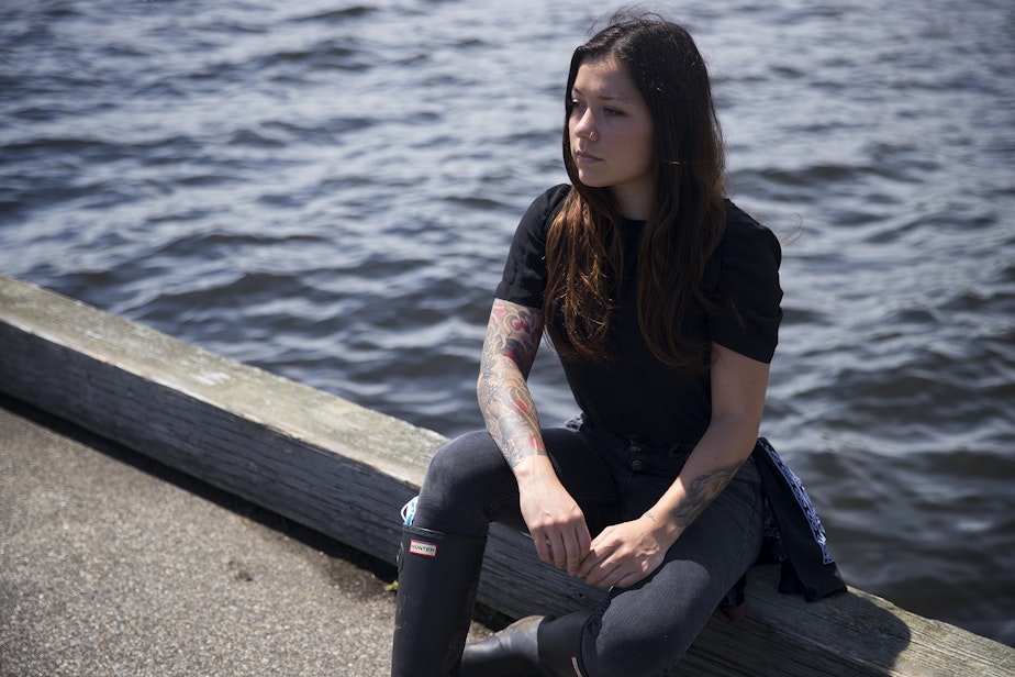 caption: Aubreanna Inda sits for a portrait on Wednesday, June 10, 2020, at a park along Lake Washington in Seattle.