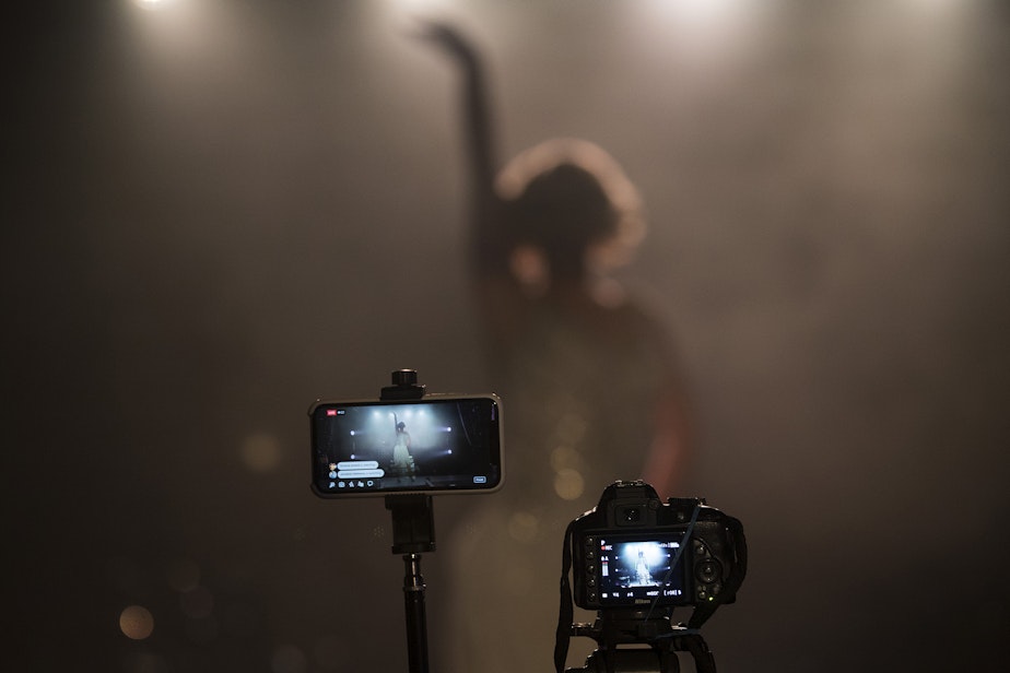 caption: Live-streaming cameras are shown as Isaac Scott performs during a virtual Le Faux happy hour show on Wednesday, May 20, 2020, at Julia's on Broadway in Seattle.