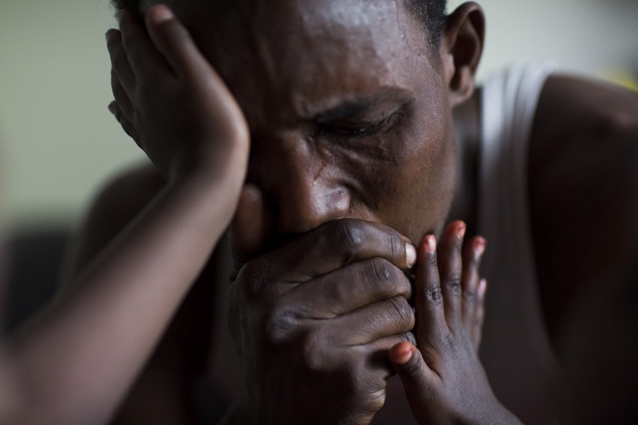 caption: Osman Mohamed, a refugee from Somalia who ended up in a camp in Kenya, cries upon hearing that his father has been having medical problems.