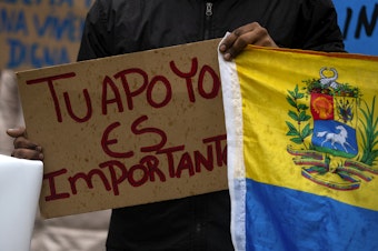 caption: “Your support is important” reads a sign, translated to English, as asylum seekers once housed at the Sleep Inn in SeaTac march to Seattle City Hall along with activists, mutual aid organizations and allies to ask for assistance with housing from Seattle city councilmembers on Tuesday, February 27, 2024, in Seattle.