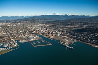caption: Aerial View of Bellingham, Washington including the waterfront redevelopment, downtown, and Mount Baker in the distance.