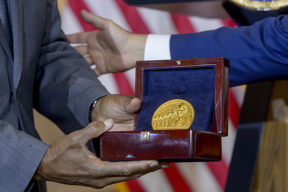 caption: House Speaker Mike Johnson, R-La., right, presents the Congressional Gold Medal to Stanley Earley III, son of Lt. Col. Charity Adams Earley, left, during a ceremony honoring the Six Triple Eight, on Capitol Hill, Tuesday, April 29, 2025, in Washington. The U.S. Army's 6888th Central Postal Directory Battalion, also known as the Six Triple Eight, was a group of Black servicewomen, serving overseas, to sort millions of pieces of mail and deliver them to the troops in the field of battle during World War II.