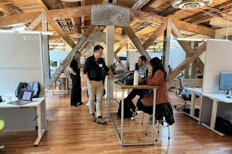 caption: AI House, on the top floor of Pier 70, is built among the trusses that hold up the roof.