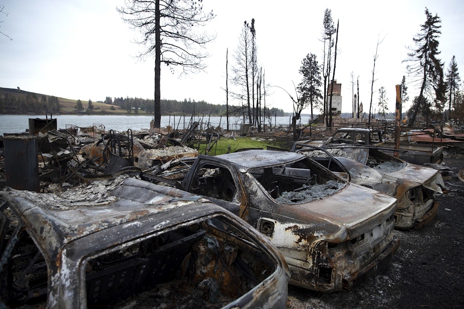caption: Homes and cars destroyed by the Gray Fire are shown on Sunday, September 3, 2023, along the west side of Silver Lake in Spokane County. Over 10,000 acres and 240 homes burned in the fire.
