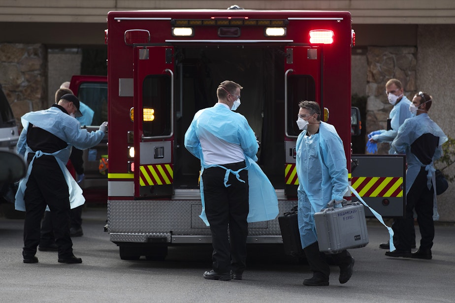 caption: First responders and members of the Kirkland Fire Department arrive at the Life Care Center of Kirkland to transport a patient to the hospital on Thursday, March 5, 2020, in Kirkland.
