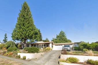 caption: A 60-foot tall cedar tree in West Seattle, called "Henry" by local tree advocates (pictured to the left), was cut down on Tuesday, April 9, 2024. Advocates say the tree's removal illuminates holes in Seattle's new tree protection ordinance. 